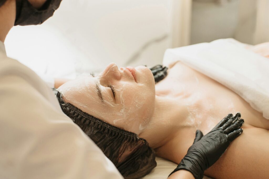 Facial peeling,, skin care. A woman receiving facials from a cosmetologist at a spa, close-up