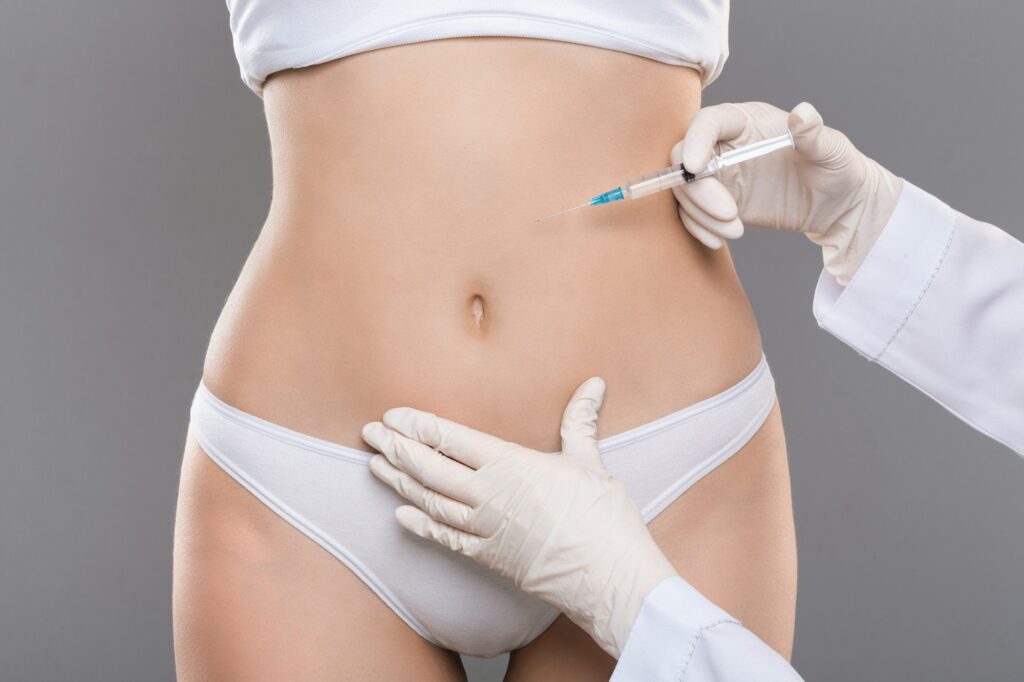 Woman having lipolysis treatment at beauty salon